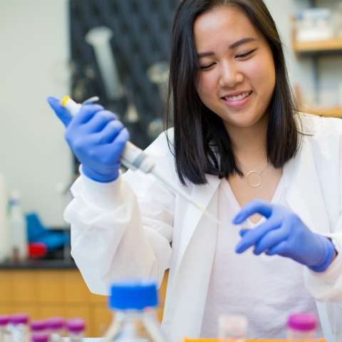 Student injecting fluid into beaker