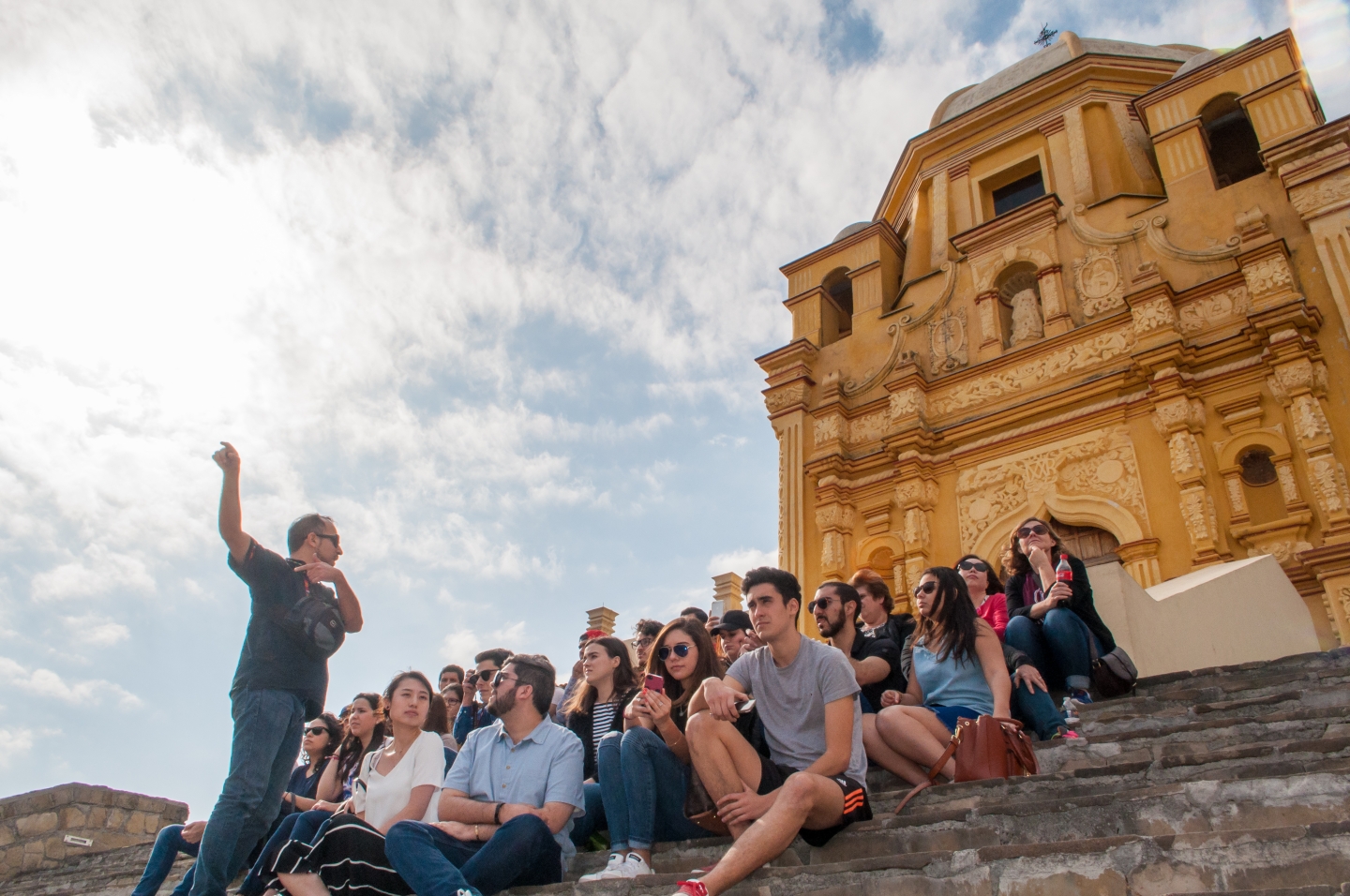 Students take part in a class on cathedral steps in Monterrey, Mexico