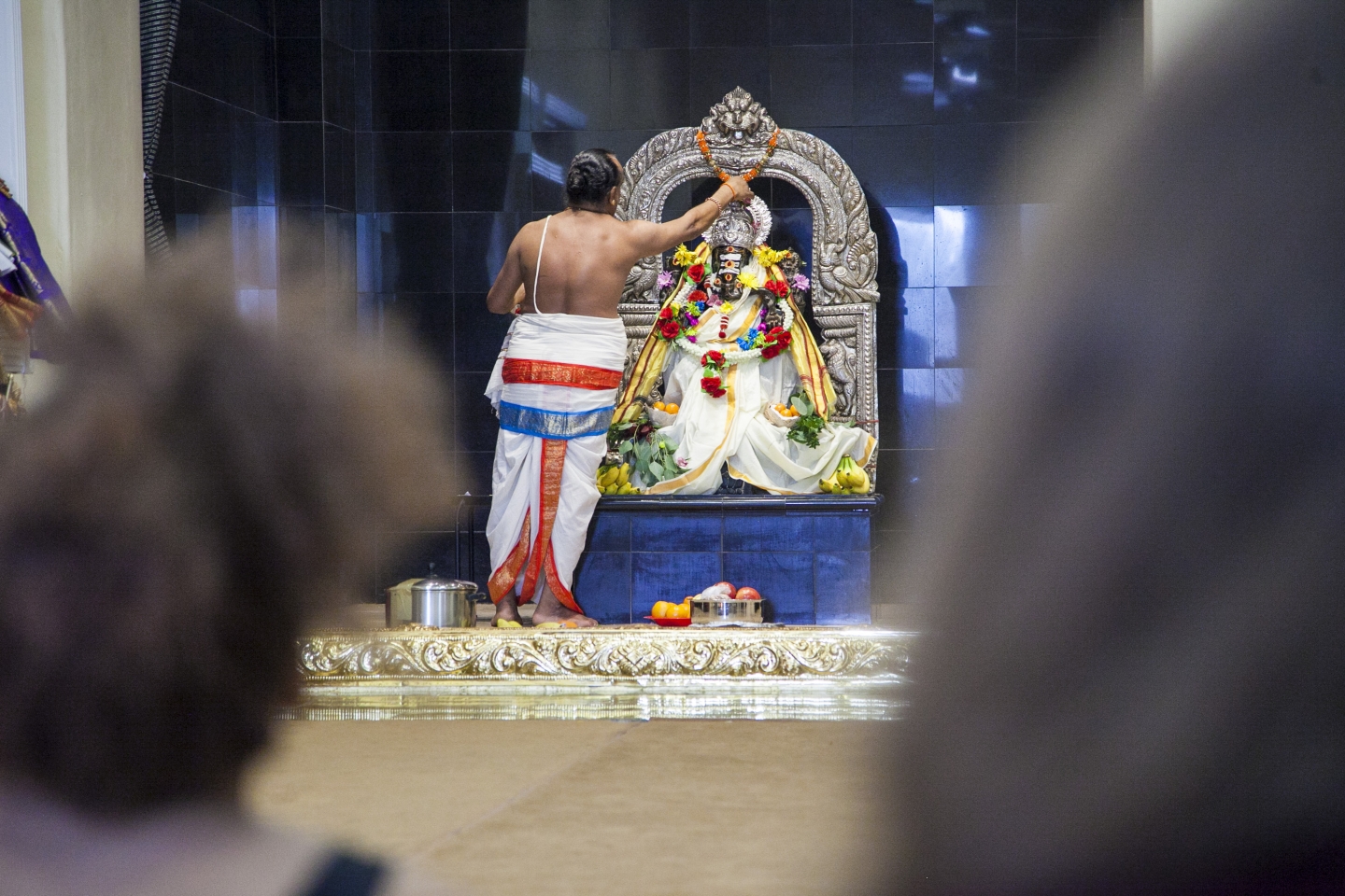 Person draping an altar with flowers