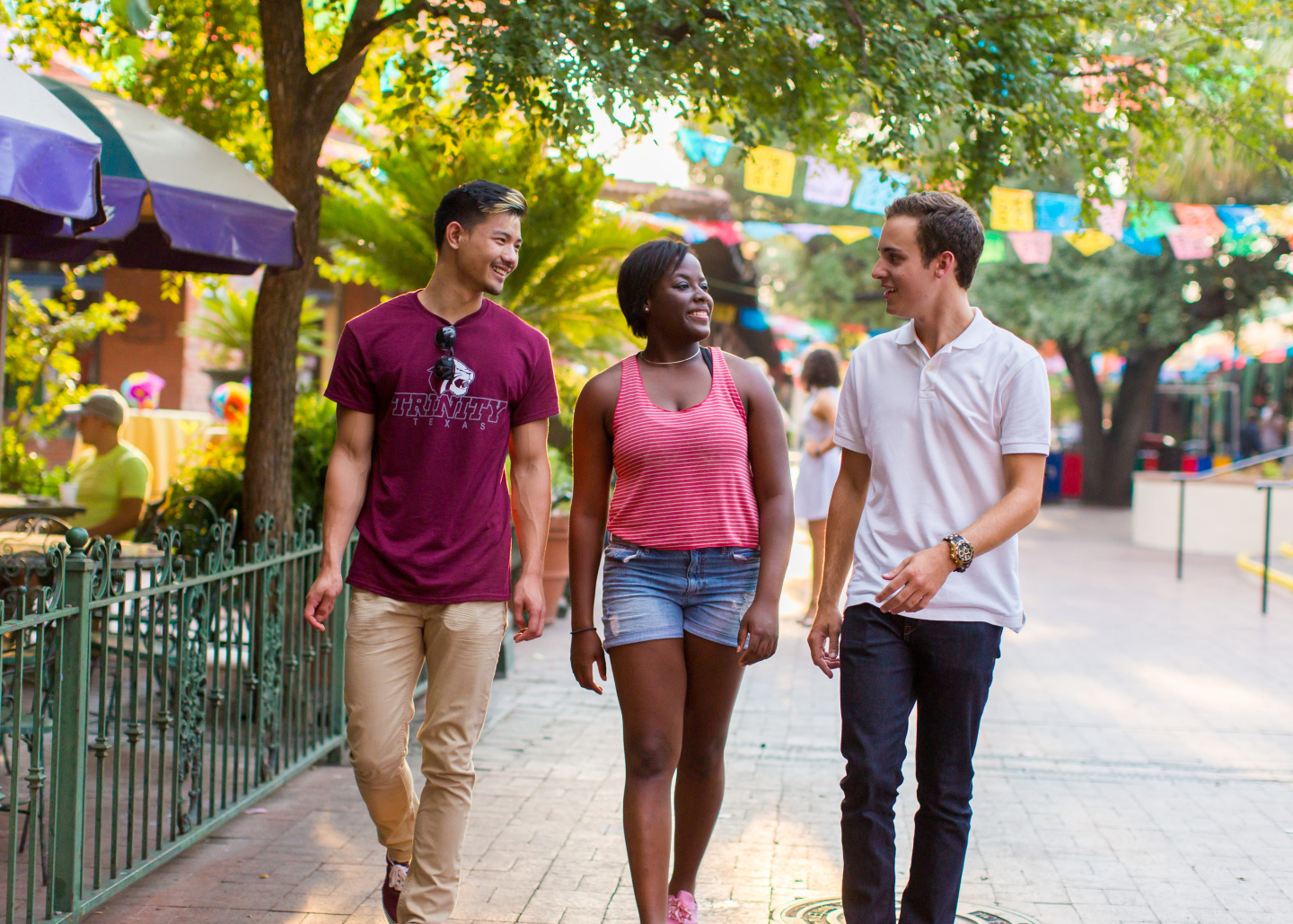 Three diverse students walking in downtown San Antonio