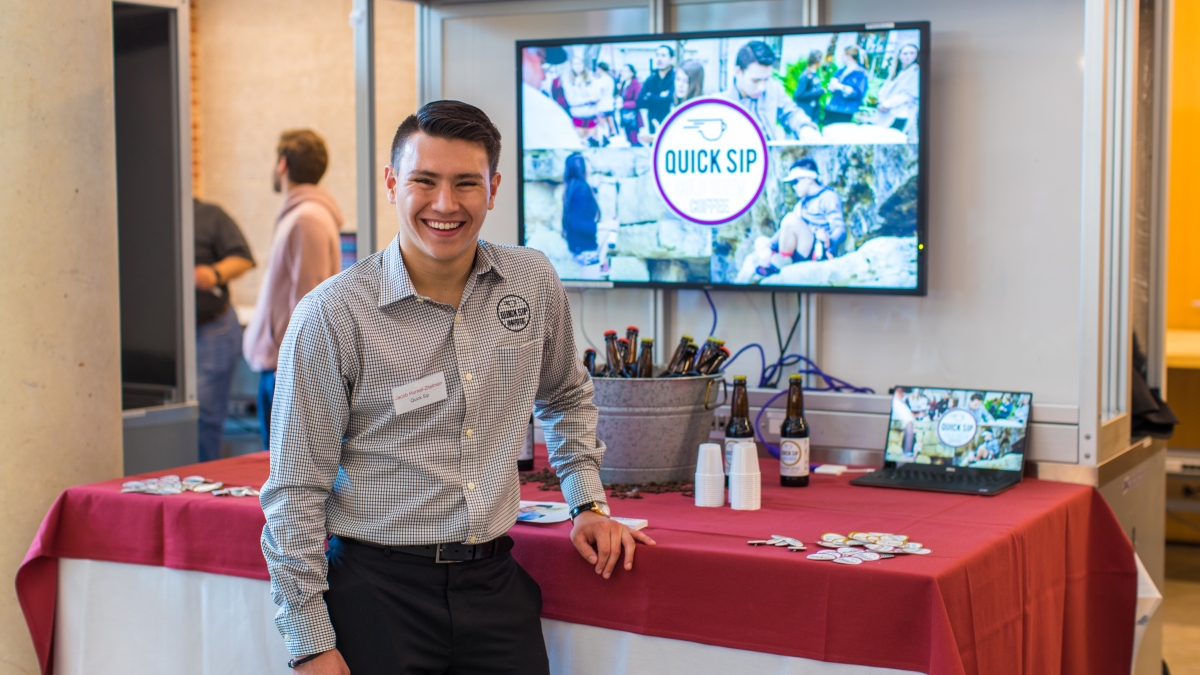 A Trinity entrepreneurship student poses with samples from their company