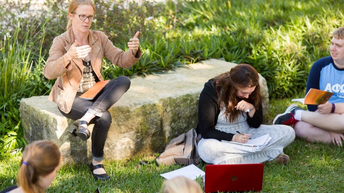 Professor giving a lecture outdoors
