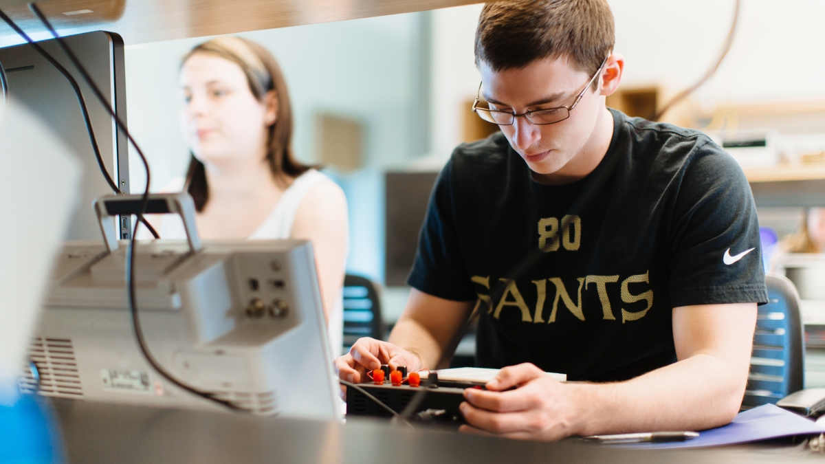 Two students working in electronics lab