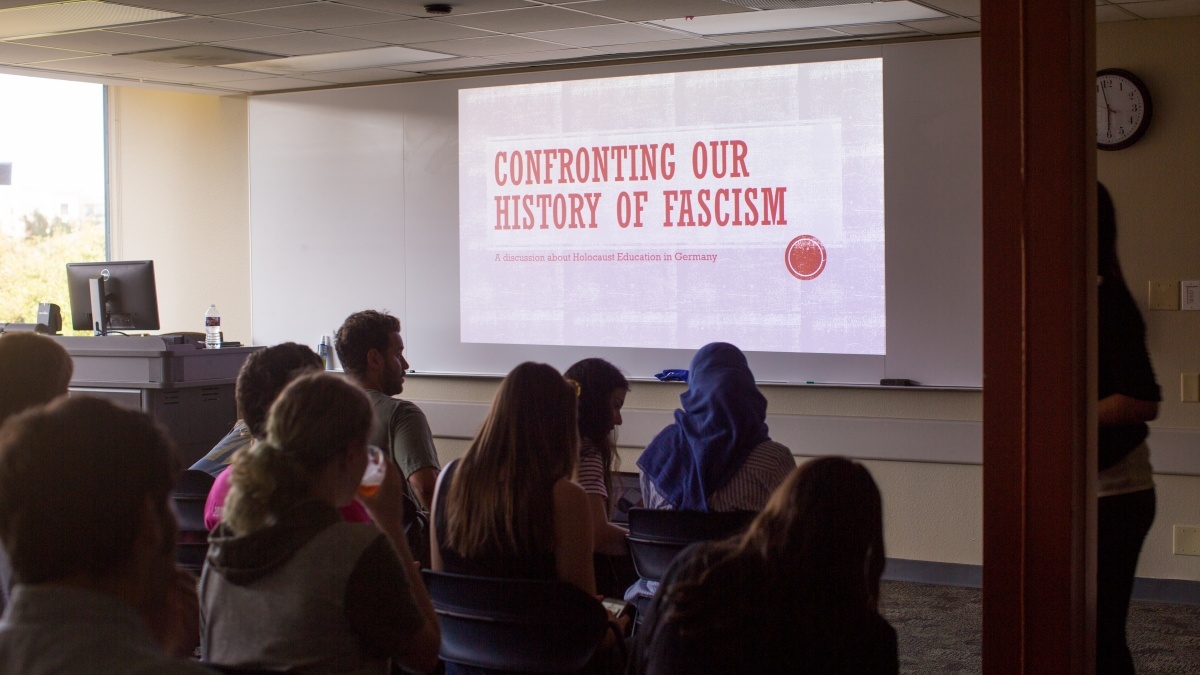 Students watching a presentation on "Confronting our History of Fascism"