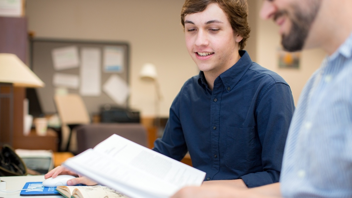 Two students discussing book