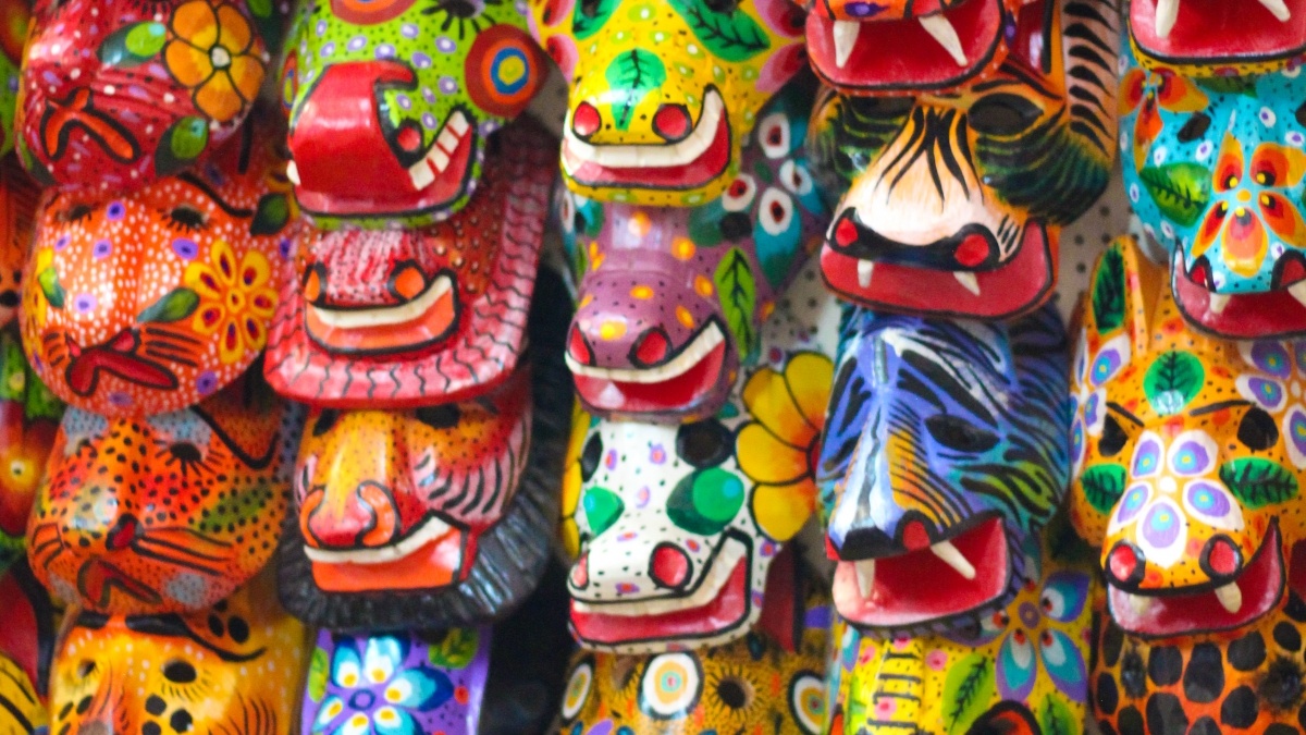 Various colorful masks hanging on a wall