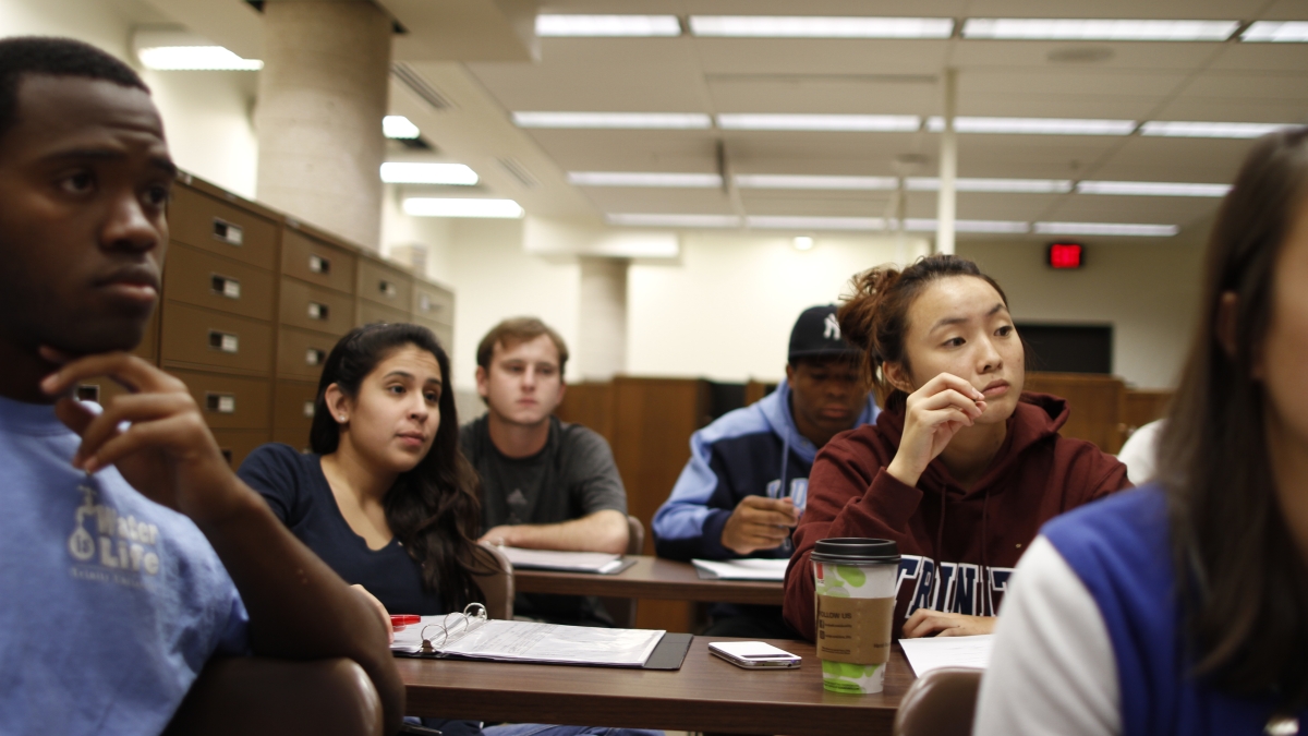 Students in classroom looking at professor