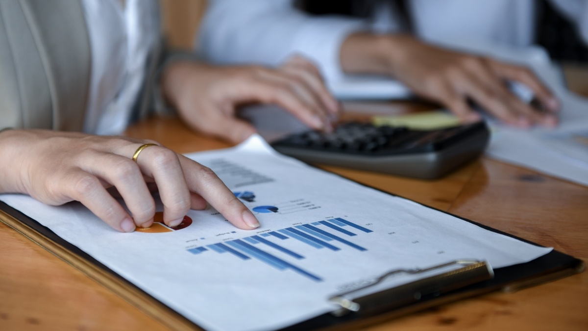 Two  people looking at a bar graph