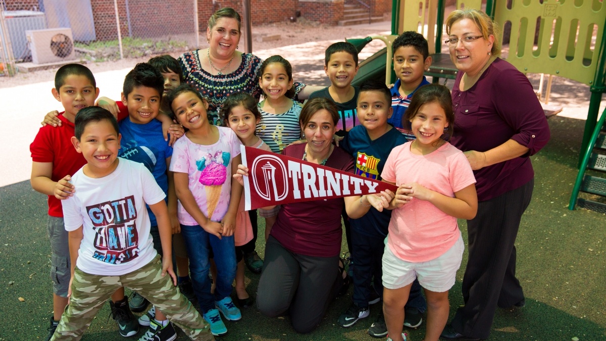 Group photo of an elementary class holding a Trinity pendent