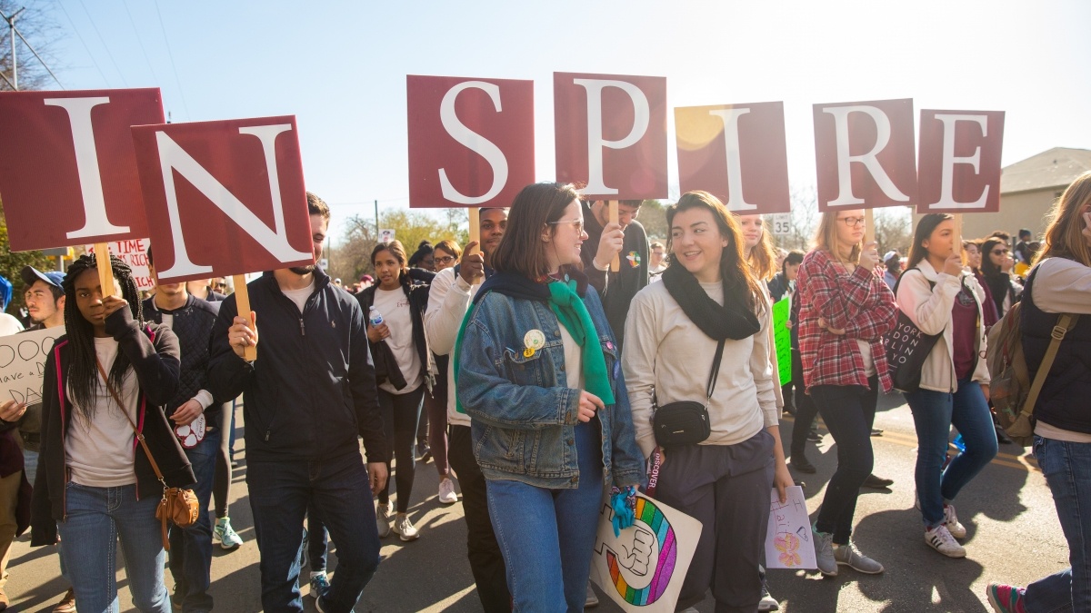Group of students demonstrating with inspire sign