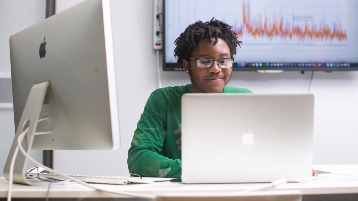 student sitting in front of a computer