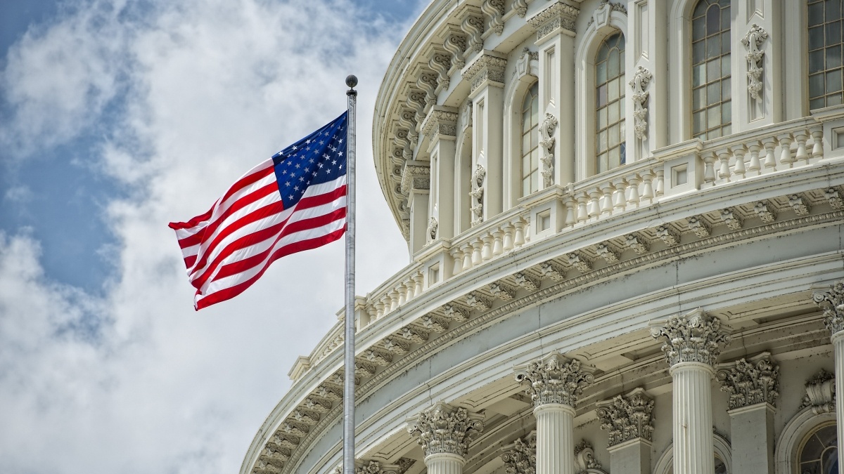 Capital building with USA flag flying in front of it
