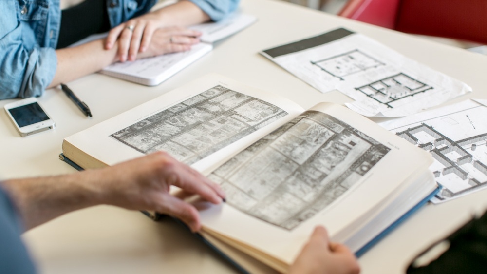 Students looking through archaeological biblical documents