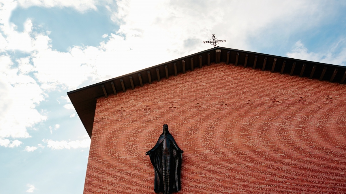 Building brick wall with a religious figure on it