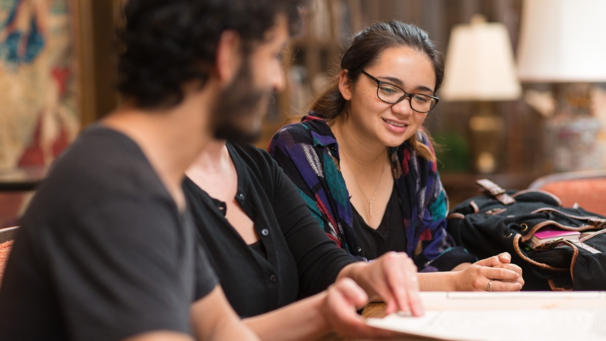 Students looking through ancient manual
